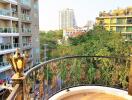 Balcony with decorative railing and city view