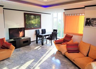 Bright and spacious living room with dining area