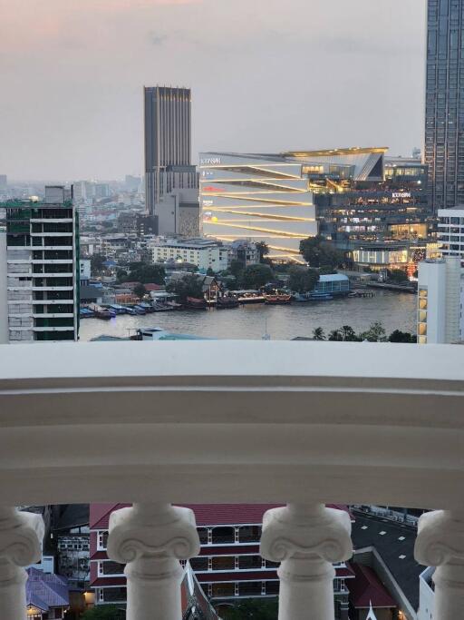 Balcony view of city skyline with modern buildings and river