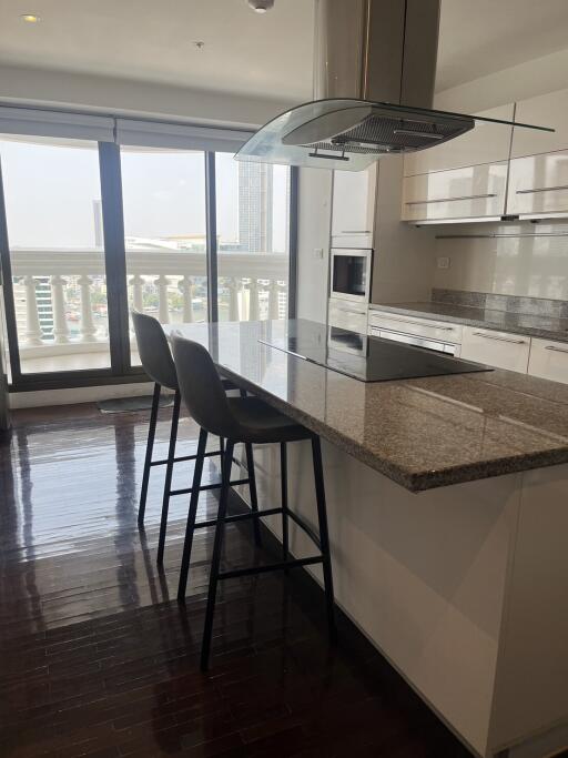 Modern kitchen with granite countertops and bar stools