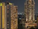 Night city view with illuminated buildings and waterway