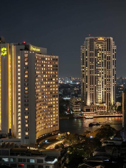 Night city view with illuminated buildings and waterway