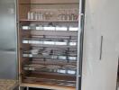 Modern kitchen cabinet with glass shelves and organized tableware