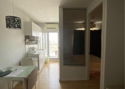 Living area with small dining table and view into the kitchen