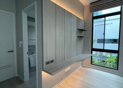 Modern bedroom with built-in desk and large window