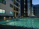 Apartment building with outdoor swimming pool at dusk