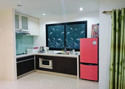 Modern kitchen with pink refrigerator