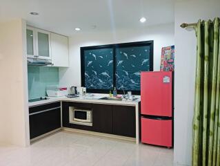 Modern kitchen with pink refrigerator