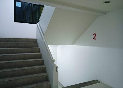 Staircase with white walls and a window