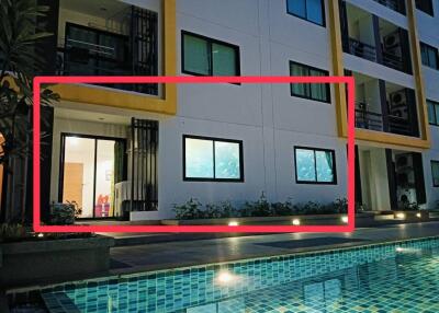 Night view of apartment building with illuminated swimming pool