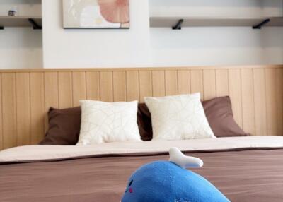 Cozy bedroom with shelves and plush toy on bed