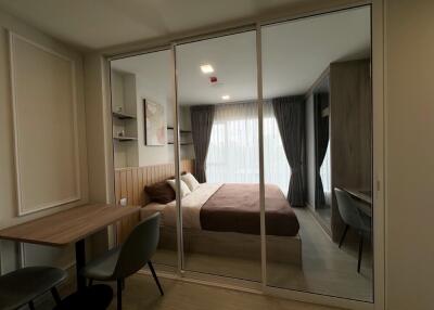 Modern bedroom with glass partition and work area