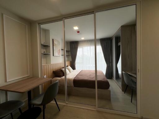 Modern bedroom with glass partition and work area