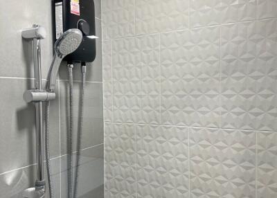 Modern bathroom with tiled walls and shower system