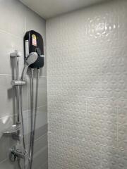 Modern bathroom with tiled walls and shower system