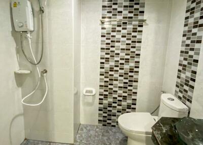 Modern bathroom with tiled walls and floor