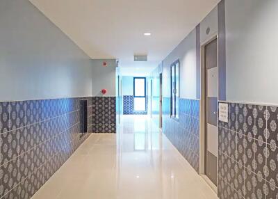 Bright and clean corridor with tiled walls