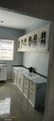 Modern kitchen with marble countertops and vintage style cabinets