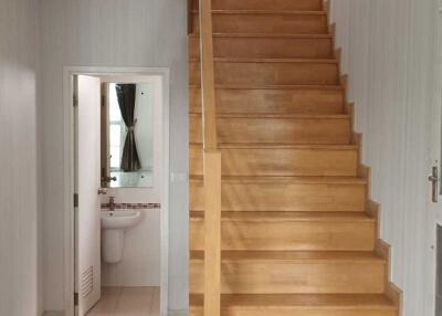 Staircase and hallway view with access to bathroom