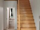 Staircase and hallway view with access to bathroom