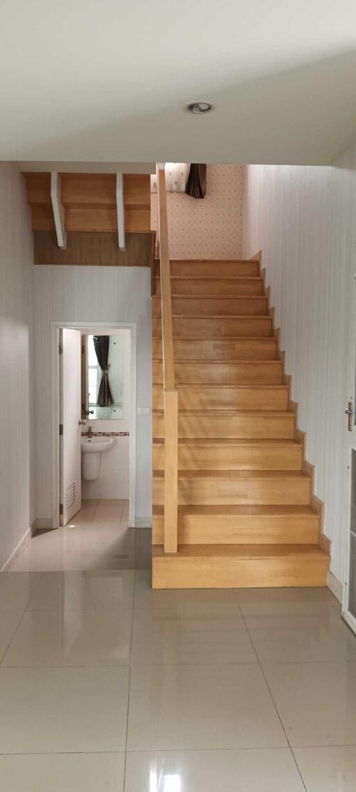 Staircase and hallway view with access to bathroom