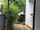 Outdoor entryway with tiled pathway and greenery