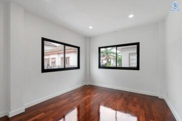 Empty room with wooden floor and windows