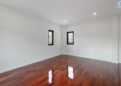 Spacious empty bedroom with wooden floor