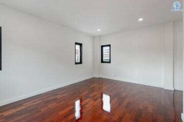 Spacious empty bedroom with wooden floor