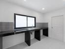 Modern kitchen with black countertops and tiled backsplash