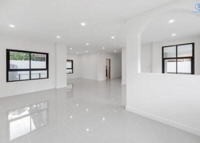 Spacious white-walled main living area with large windows