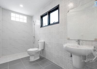 Modern bathroom with shower, toilet, and sink