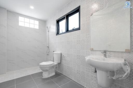 Modern bathroom with shower, toilet, and sink