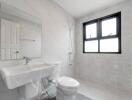 Modern bathroom with large window and wall-mounted sink