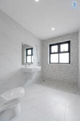 Spacious and modern bathroom with a large window, sink, mirror, and toilet.