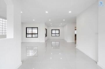 Spacious and well-lit living room with modern white interior and large windows