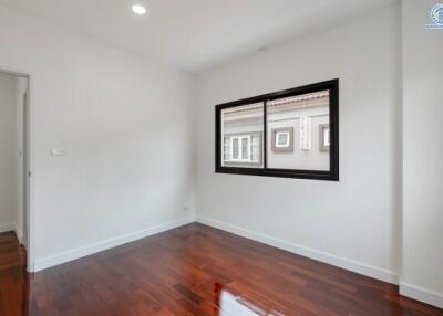 Bright and empty bedroom with wooden flooring