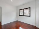 Bright and empty bedroom with wooden flooring