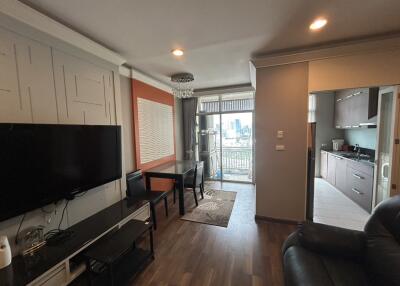 Modern living room with a view of the kitchen and balcony