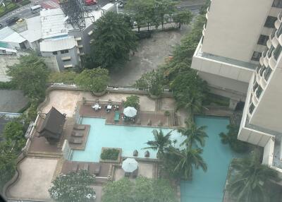 Aerial view of a building with a swimming pool and outdoor seating area