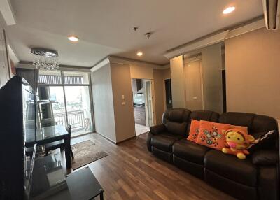 Modern living room with balcony and adjacent kitchen area