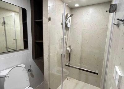 Modern bathroom with glass shower enclosure and toilet