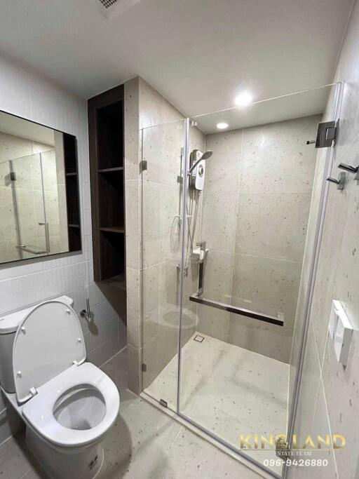 Modern bathroom with glass shower enclosure and toilet