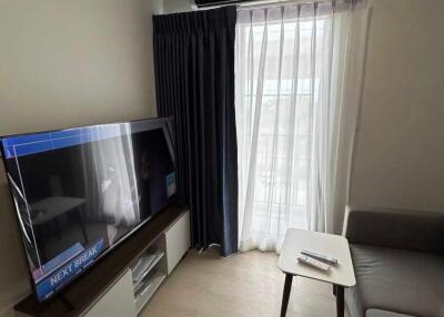 Modern living room with a sofa, TV, air conditioner, and a coffee table