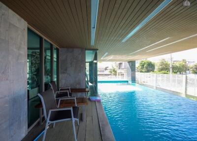 Outdoor pool area with seating and modern design