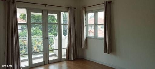 Bright bedroom with large windows and a door to the balcony