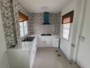 Modern kitchen with tiled backsplash and white cabinets