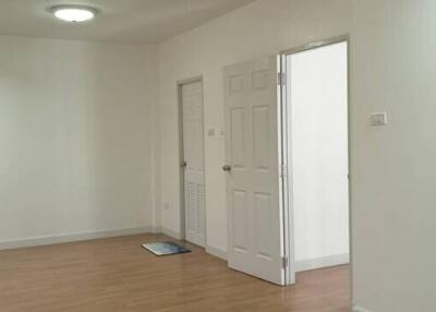 Empty room with wooden floor and white walls