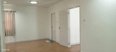 Empty room with wooden floor and white walls