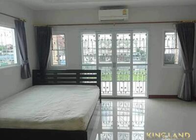 Spacious bedroom with large windows and balcony access